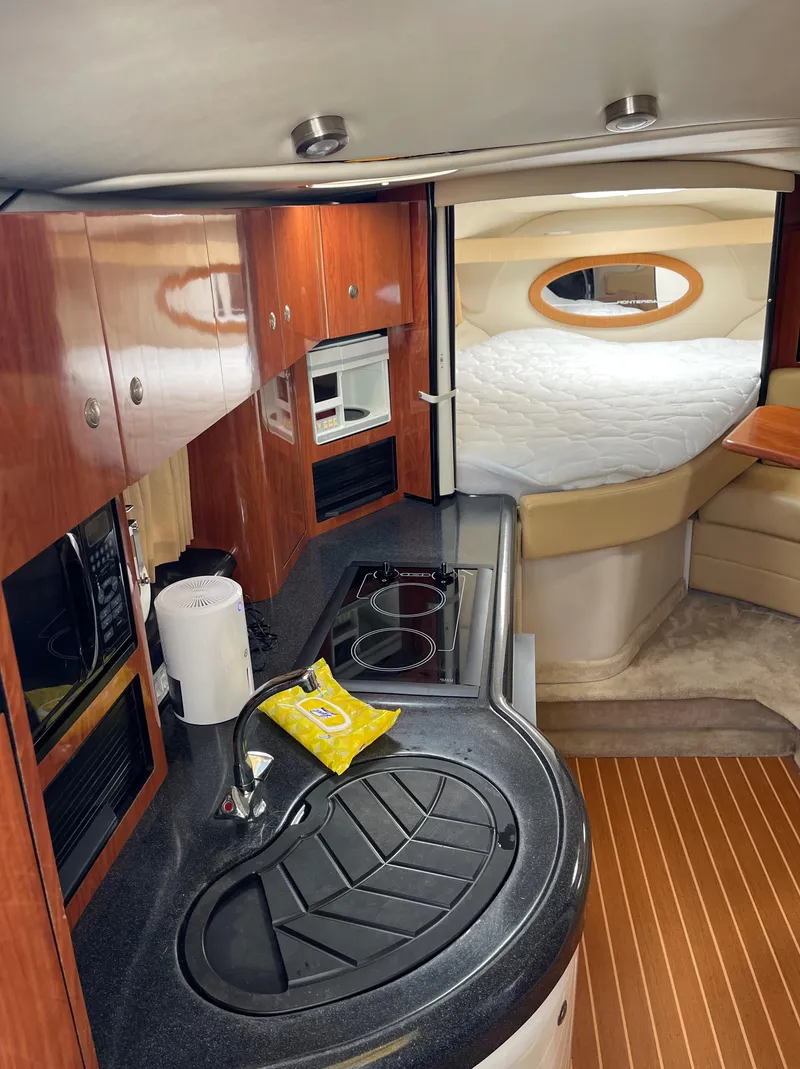 Slide: The Image of Interior of 2006 Monterey 322 Cruiser with kitchen and sleeping area. - 11