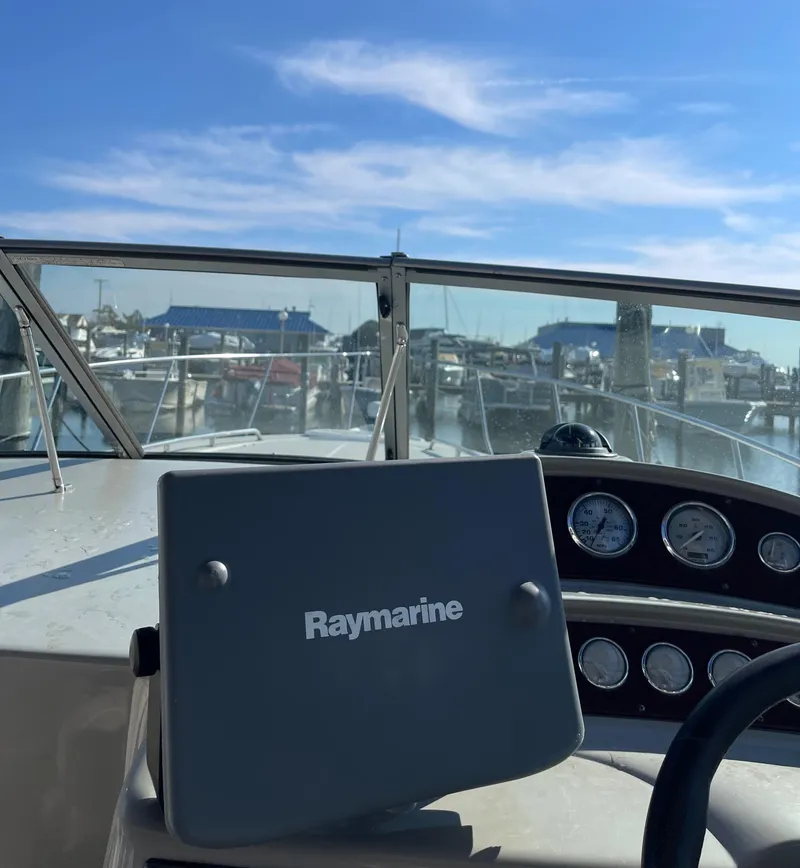 Slide: The Image of 2006 Monterey 322 Cruiser boat dashboard with Raymarine navigation system. - 14