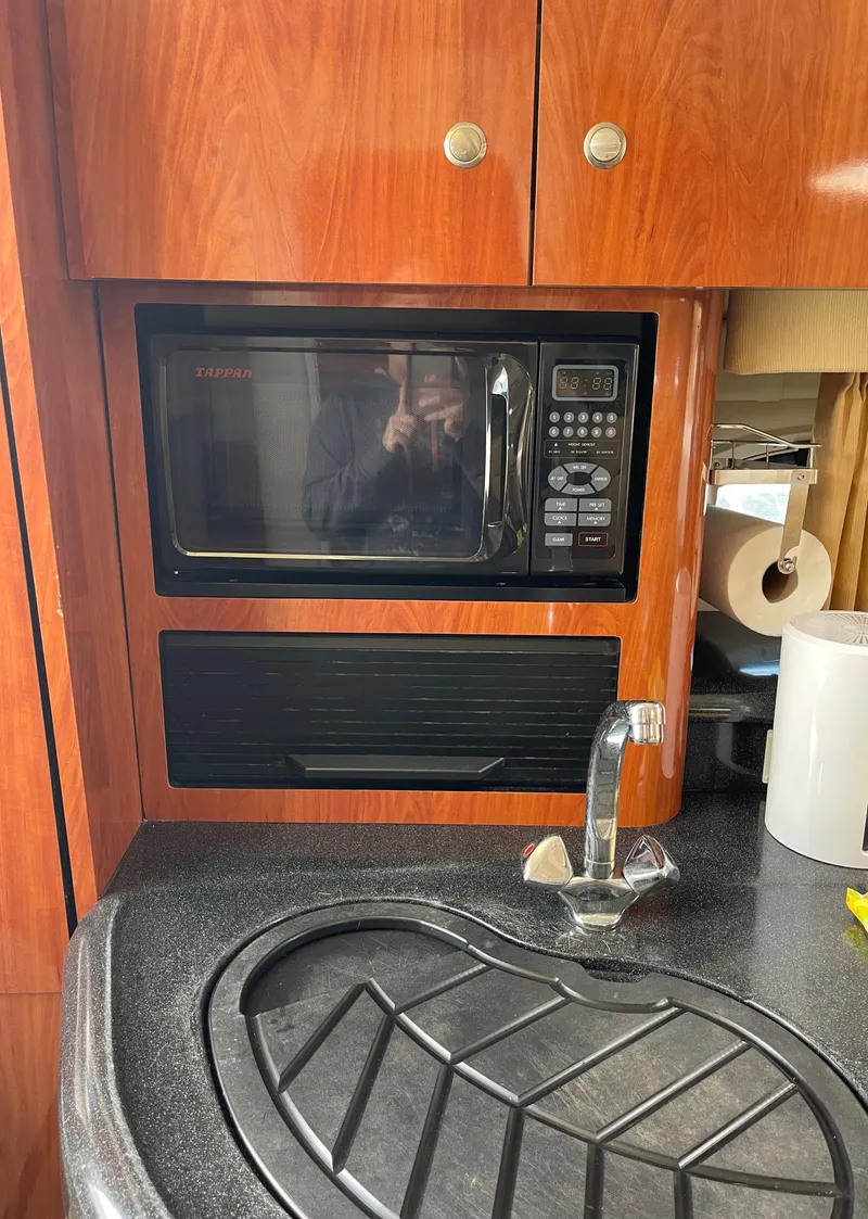 Slide: The Image of 2006 Monterey 322 Cruiser kitchen with microwave and sink. - 16