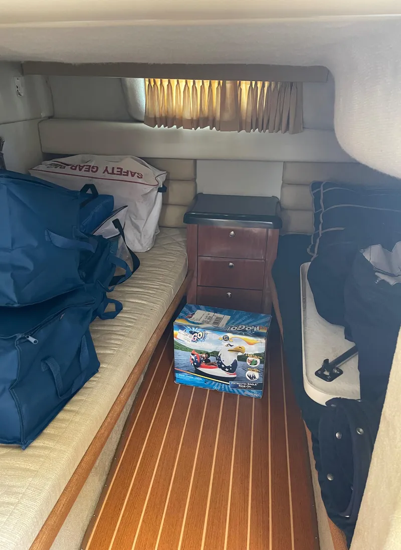 Slide: The Image of Interior cabin of a 2006 Monterey 322 Cruiser with storage bags and a toy box. - 18