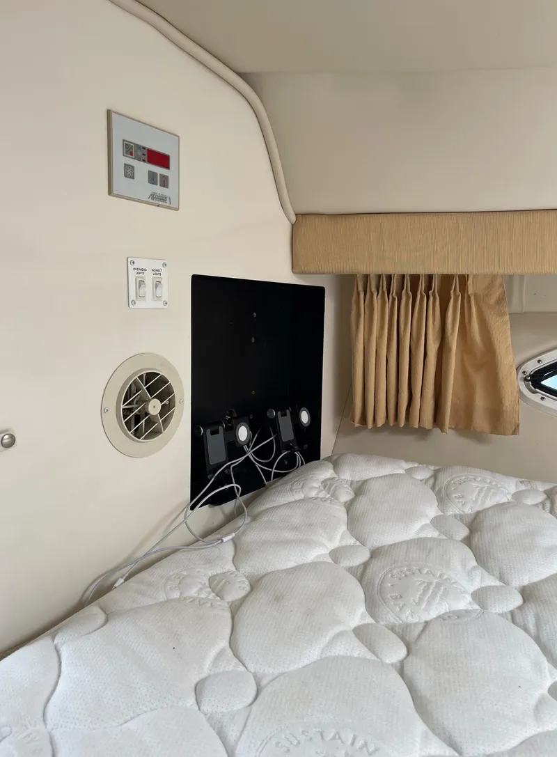 Slide: The Image of Interior cabin of a 2006 Monterey 322 Cruiser with bed, control panel, and window. - 19