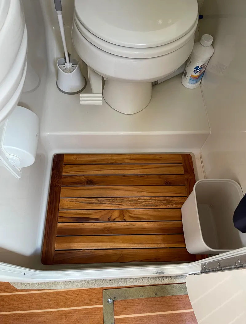Slide: The Image of 2006 Monterey 322 Cruiser bathroom with wooden floor mat and toilet. - 21