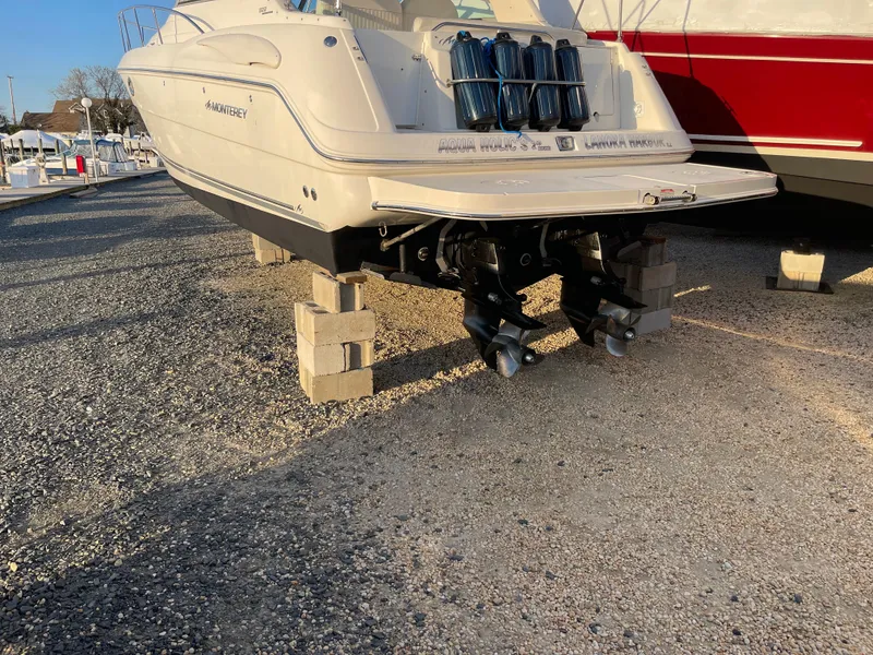 Slide: The Image of 2006 Monterey 322 Cruiser boat on blocks in a marina. - 4