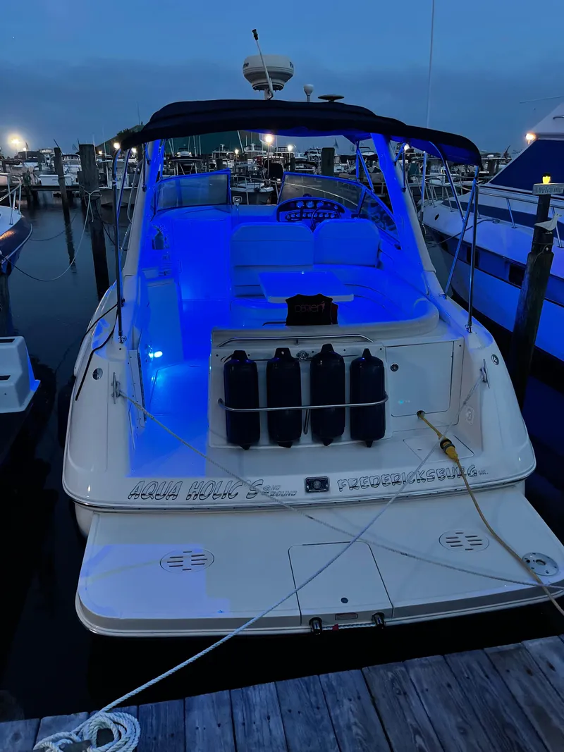 Slide: The Image of 2006 Monterey 322 Cruiser docked at night with blue interior lights. - 6