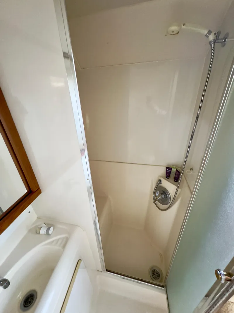 Slide: The Image of 1998 Bayliner 3388 Command Bridge Motoryacht bathroom with shower and sink. - 10