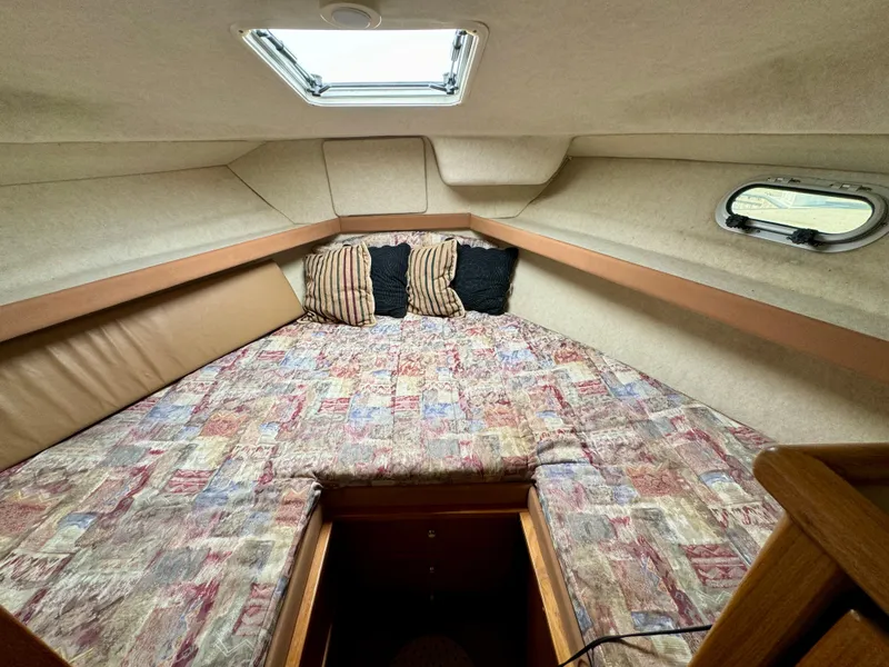 Slide: The Image of 1998 Bayliner 3388 Command Bridge Motoryacht cabin with patterned bedding and pillows. - 11