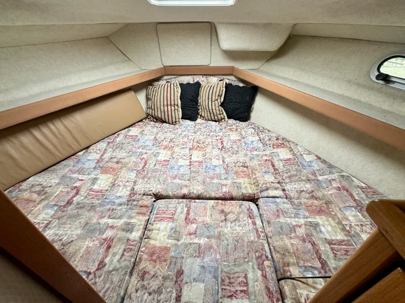Slide: The Image of Cozy cabin interior of 1998 Bayliner 3388 Command Bridge Motoryacht with patterned bedding. - 12