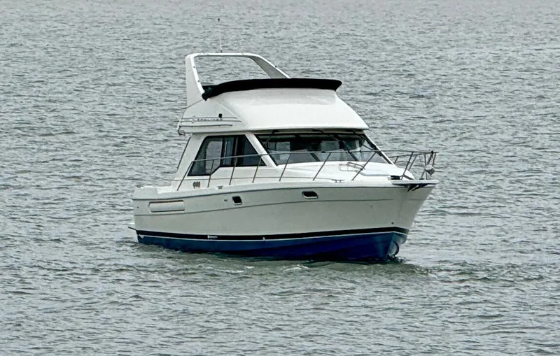 Slide: The Image of 1998 Bayliner 3388 Command Bridge Motoryacht cruising on open water. - 3