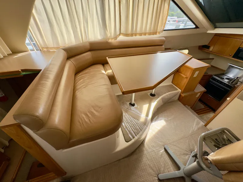Slide: The Image of Interior of 1998 Bayliner 3388 Command Bridge Motoryacht with dining area and kitchenette. - 6