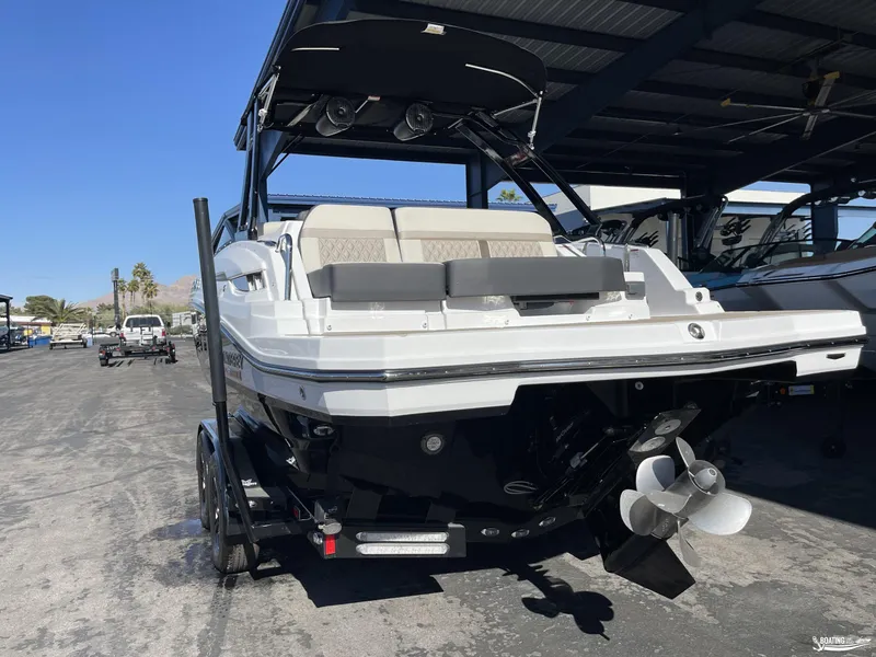 Slide: The Image of 2024 Monterey M4 boat on trailer, rear view under covered storage. - 2