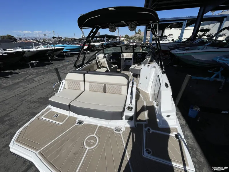 Slide: The Image of 2024 Monterey M4 boat with spacious seating and modern design at a marina. - 4