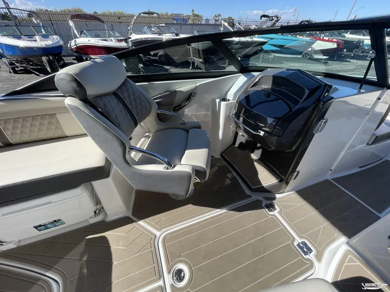 Slide: The Image of 2024 Monterey M4 boat interior with captain's chair and dashboard, displayed at a boat dealership. - 7