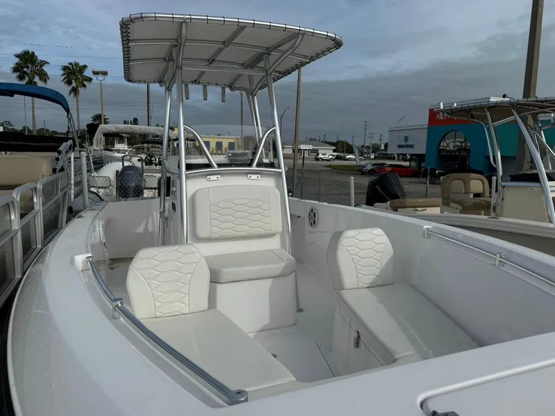 Slide: The Image of 2023 Aquasport 22 CC center console boat with white seating and T-top. - 3