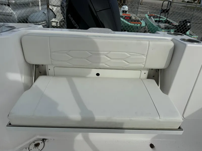 Slide: The Image of 2023 Aquasport 22 CC boat with white cushioned seating. - 4