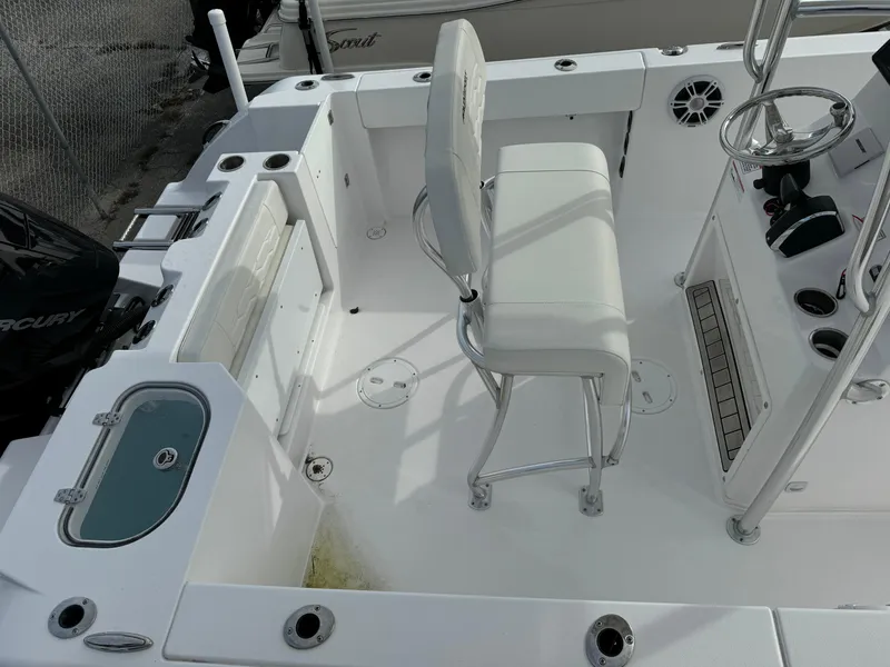 Slide: The Image of 2023 Aquasport 22 CC center console boat interior with seating and steering wheel. - 7