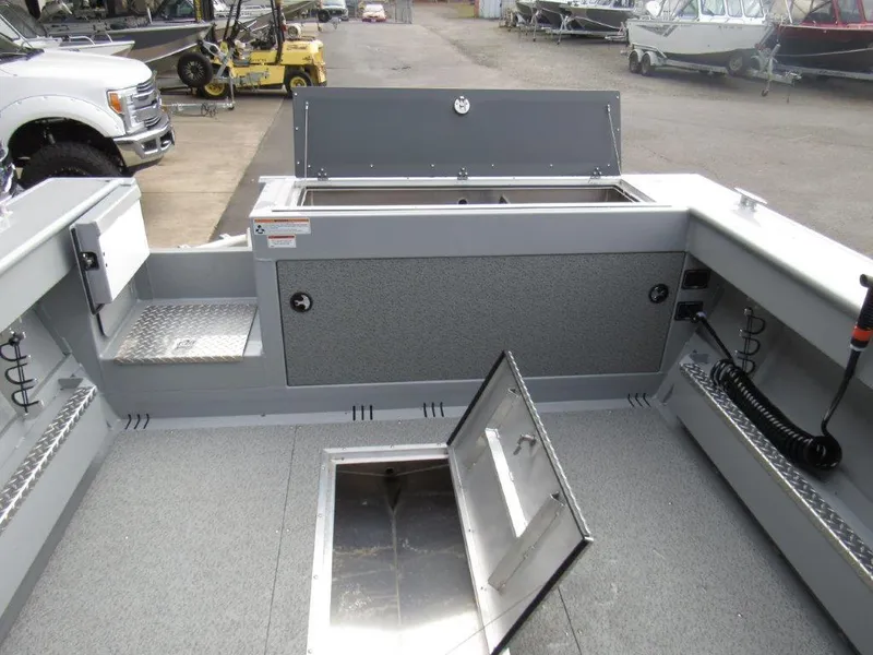 Slide: The Image of 2024 Hewescraft 220 OCEAN PRO HT FC boat interior with storage compartments open. - 11