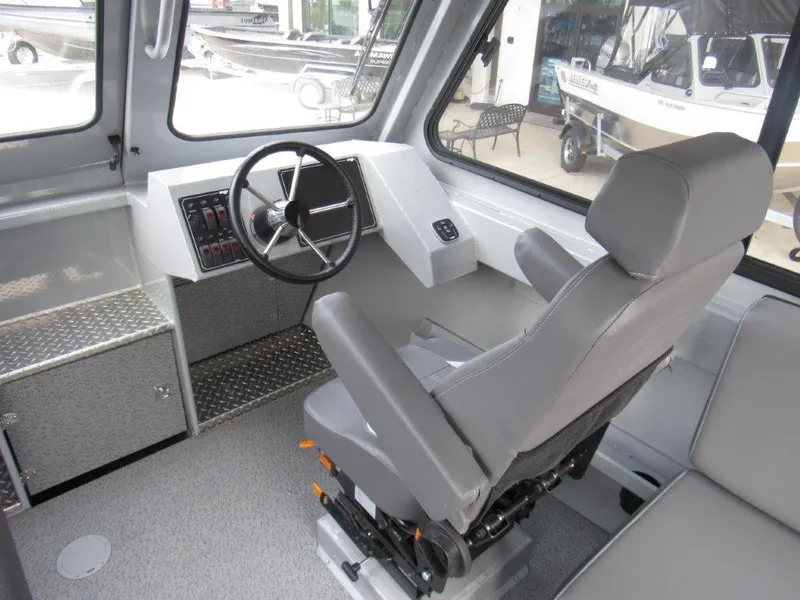 Slide: The Image of 2024 Hewescraft 220 OCEAN PRO HT FC boat interior with steering wheel and captain's chair. - 12