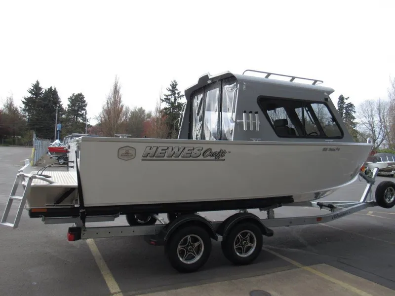 Slide: The Image of 2024 Hewescraft 220 Ocean Pro HT FC boat on a trailer in a parking lot. - 5