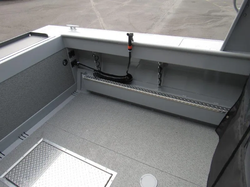 Slide: The Image of 2024 Hewescraft 220 OCEAN PRO HT FC interior, featuring storage compartments and durable flooring. - 9