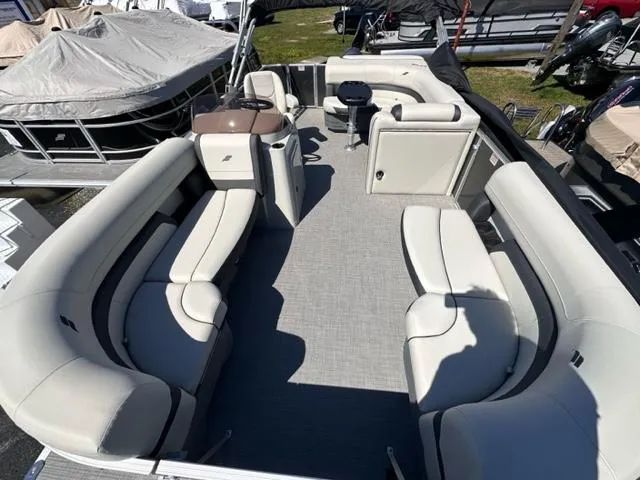 Slide: The Image of 2024 Starcraft EX 20 C pontoon boat with spacious seating and modern design. - 1