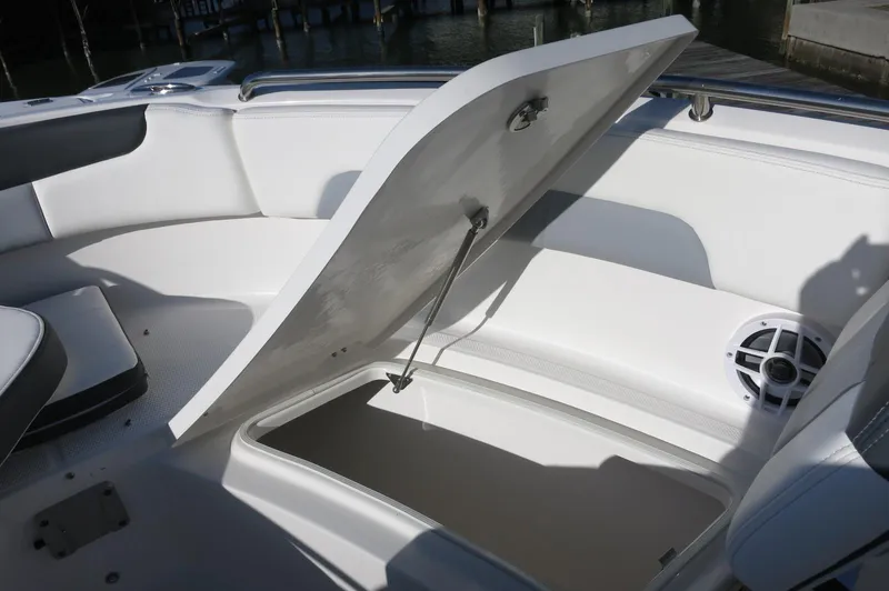 Slide: The Image of 2024 Robalo 222 Explorer CC boat with open storage compartment. - 15