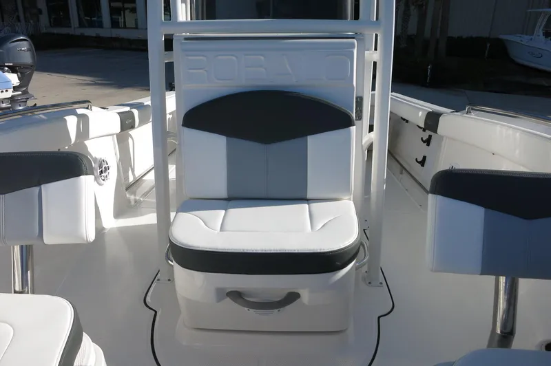 Slide: The Image of 2024 Robalo 222 Explorer CC center console seating area with cushioned seats. - 16