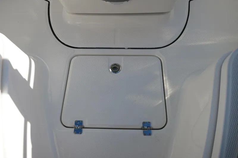 Slide: The Image of 2024 Robalo 222 Explorer CC center console storage compartment. - 17