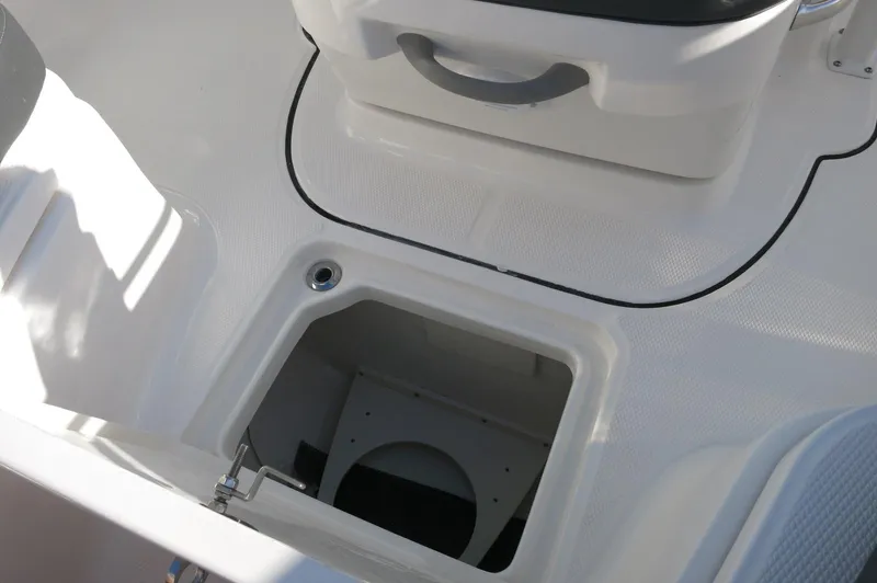 Slide: The Image of 2024 Robalo 222 Explorer CC center console storage compartment. - 18