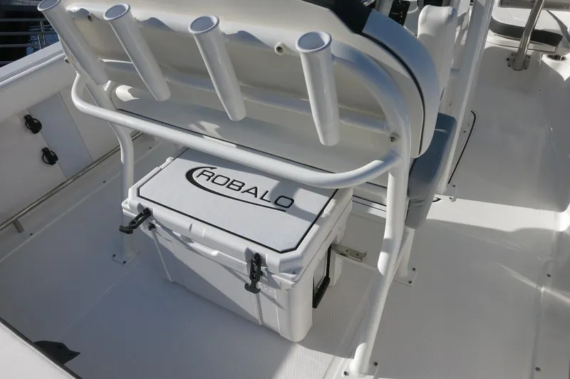 Slide: The Image of 2024 Robalo 222 Explorer CC boat interior with cooler and rod holders. - 27