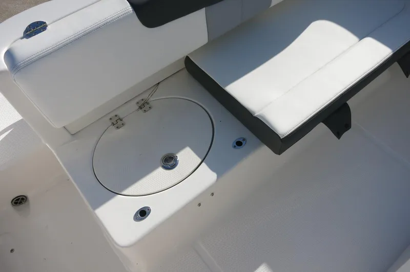 Slide: The Image of 2024 Robalo 222 Explorer CC boat seating and storage compartment. - 30
