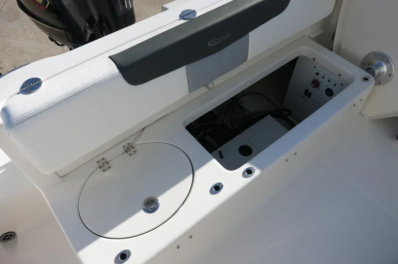 Slide: The Image of 2024 Robalo 222 Explorer CC boat storage compartment and seating area. - 32