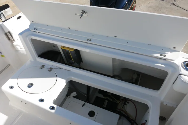 Slide: The Image of 2024 Robalo 222 Explorer CC boat storage compartments and engine access. - 37