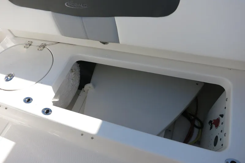 Slide: The Image of 2024 Robalo 222 Explorer CC storage compartment and seating area. - 40