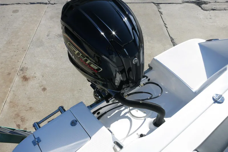 Slide: The Image of 2024 Robalo 222 Explorer CC boat with a powerful outboard motor. - 41