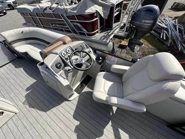 Slide: The Image of 2024 Starcraft EX 20 Q DH boat interior with steering console and seating. - 4