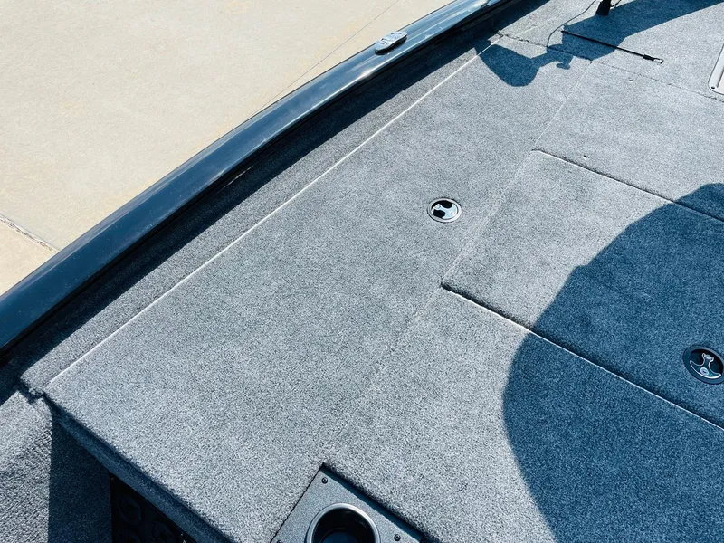 Slide: The Image of 2024 Tracker Pro Team 195 TXW Tournament Edition boat deck with carpeted surface. - 13