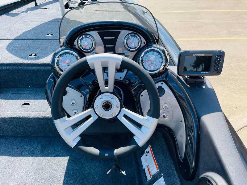 Slide: The Image of 2024 Tracker Pro Team 195 TXW Tournament Edition boat dashboard with steering wheel and gauges. - 26