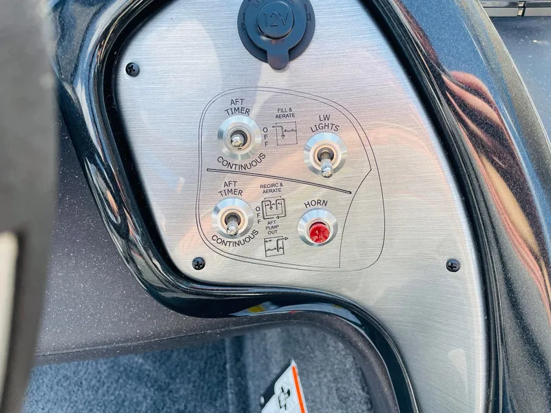 Slide: The Image of 2024 Tracker Pro Team 195 TXW Tournament Edition control panel with switches and horn button. - 30
