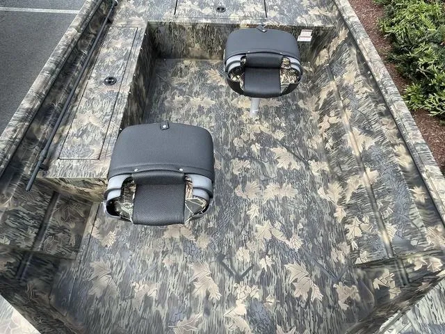 Slide: The Image of 2023 Crestliner 1760 Retriever Jon Deluxe boat with camouflage interior and two seats. - 5