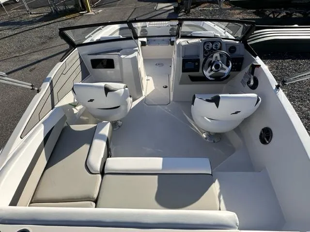 Slide: The Image of 2024 Starcraft SVX 190 boat interior with seating and steering console. - 2