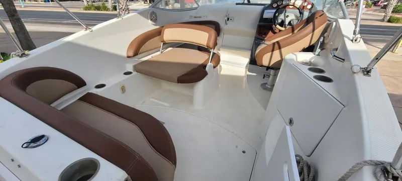 Slide: The Image of 2005 Bayliner 265 boat interior with brown and white seating. - 2