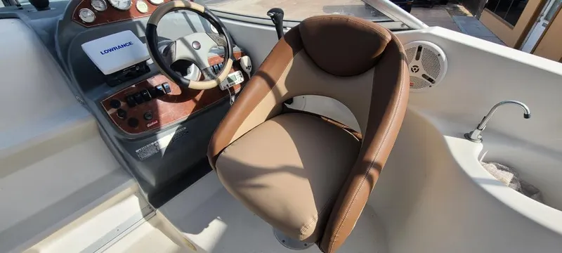 Slide: The Image of Captain's seat and helm of a 2005 Bayliner 265 boat with steering wheel and controls. - 3