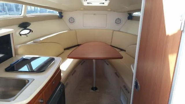 Slide: The Image of 2005 Bayliner 265 interior with dining area and kitchenette. - 4