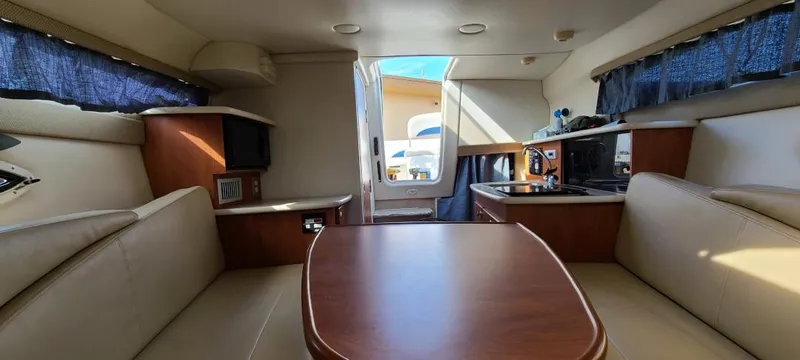 Slide: The Image of Interior of a 2005 Bayliner 265 boat with seating and kitchenette. - 8