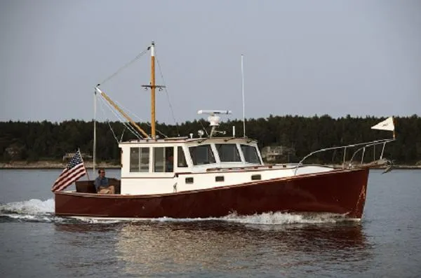 The Image of Classic 2005 John Williams Custom 38 boat cruising on calm waters with American flag. - 0