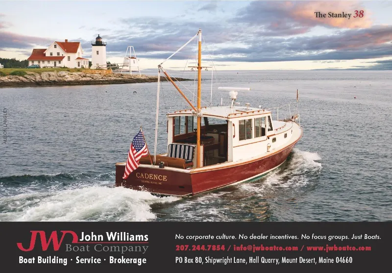 Slide: The Image of Boat cruising near lighthouse, John Williams Custom 38, 2005, with American flag, scenic coastal view. - 13