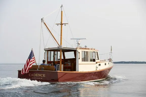 Slide: The Image of 2005 John Williams Custom 38 boat "Cadence" cruising with American flag on calm waters. - 17