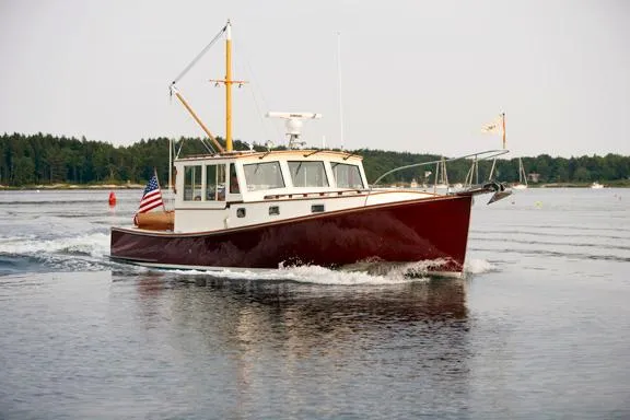 Slide: The Image of Classic 2005 John Williams Custom 38 boat cruising on a calm lake. - 18