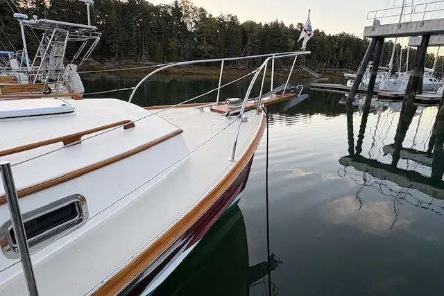 Slide: The Image of 2005 John Williams Custom 38 boat docked in serene marina with calm waters. - 19