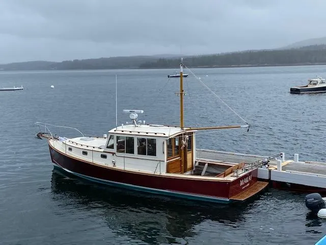 Slide: The Image of A 2005 John Williams Custom 38 boat docked on a calm, overcast day. - 2